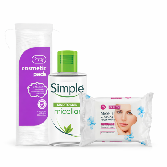Simple micellar water bottle with cosmetic pads and face wipes on a white background