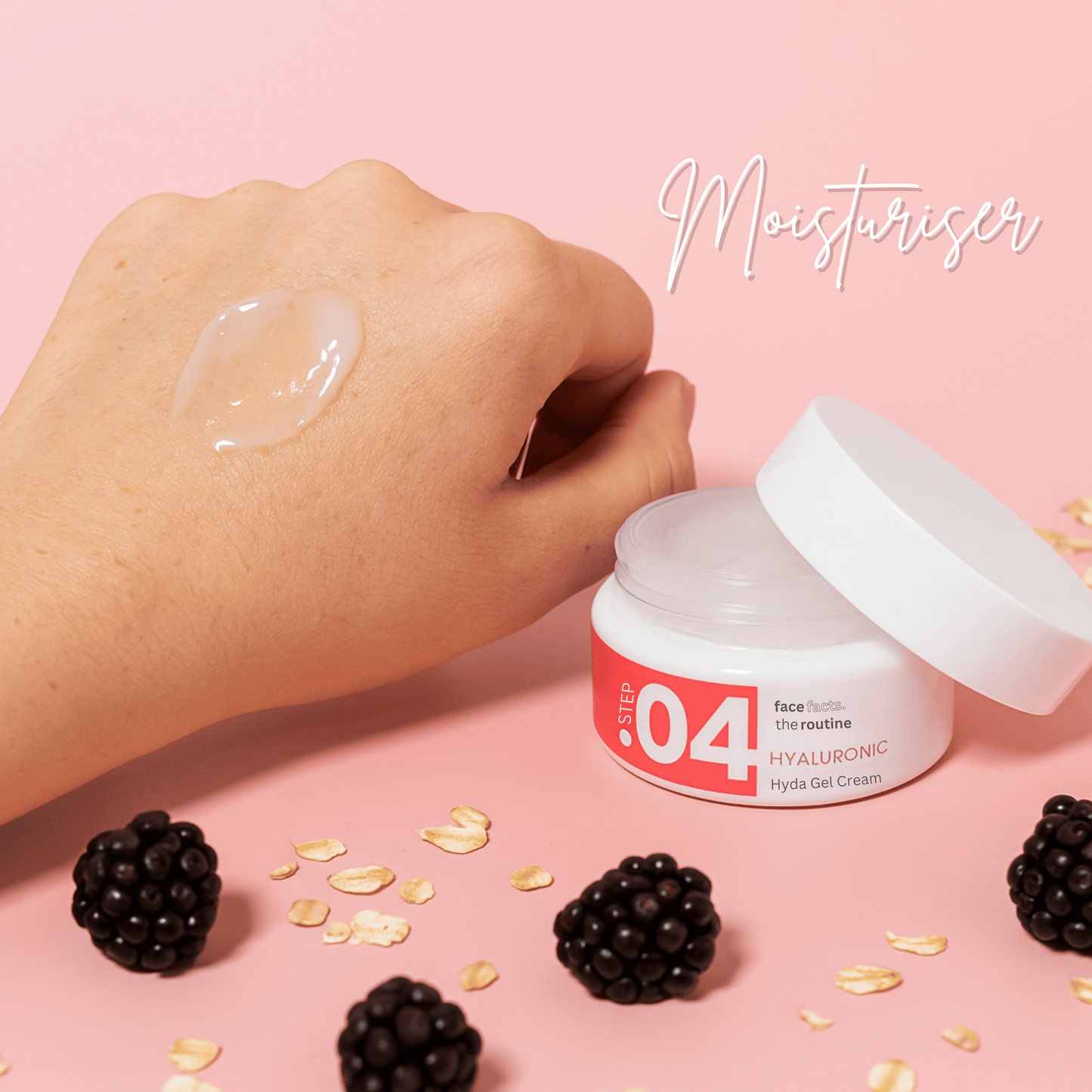 Hyaluronic Hydra Gel Cream swatched on hand, surrounded by oats and blackberries, showing hydrating jelly texture.