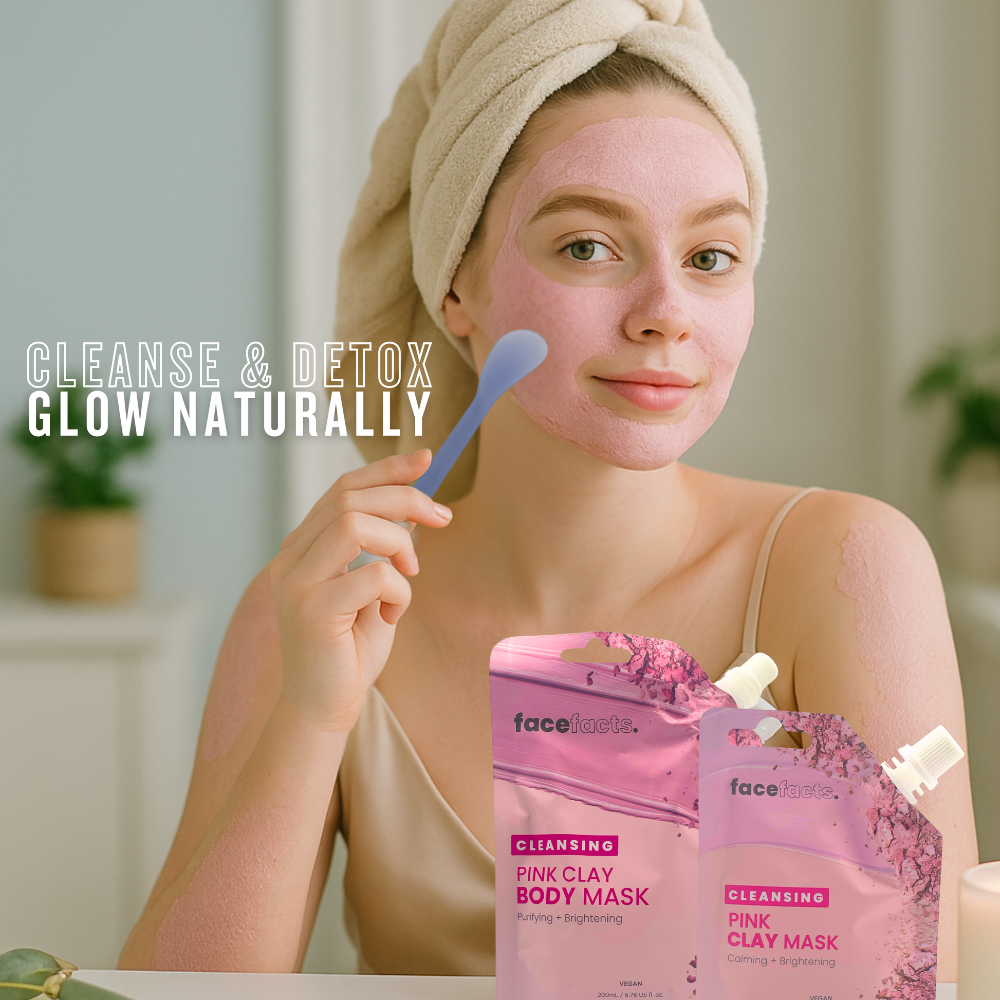 Woman applying pink clay body mask using spatula for cleansing, detoxifying and brightening skin