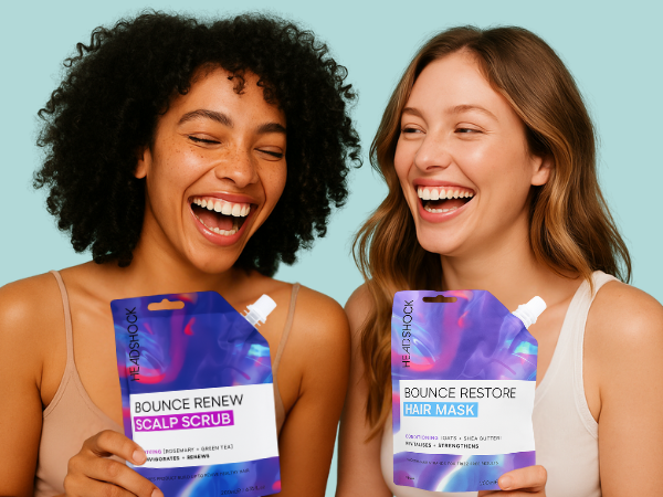 Two women holding scalp scrub and hair mask products, showcasing a complete hair care routine for healthier, shinier hair.