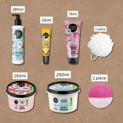Flat lay showing sizes of each bath gift set item including shower gel, lip balm, creams, scrub, bath puff, and bath bomb