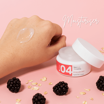 Hyaluronic Hydra Gel Cream swatched on hand, surrounded by oats and blackberries, showing hydrating jelly texture.