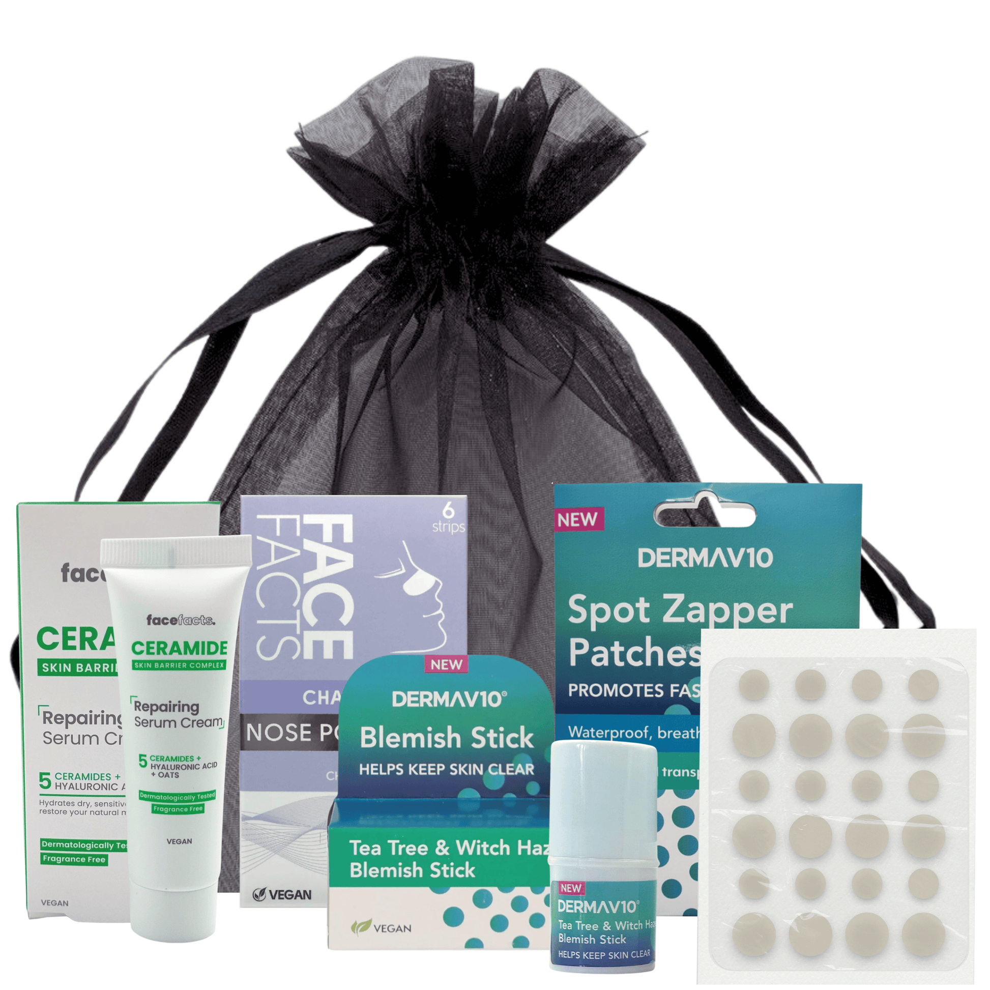 Flat lay of spot care kit contents in black organza bag, ideal skincare gift for teens and women
