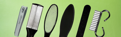 A set of black and silver foot care tools including nail clipper, foot file, rasp, emery board, and nail brush arranged on a light green background — ideal for home pedicures and smooth feet.